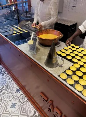 a woman is preparing food in a kitchen at Porto Bello - Apartamento - 5 in Porto