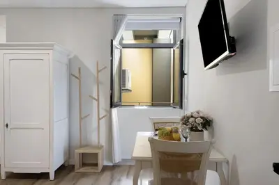a room with a table with a mirror and a window at Porto Bello - Apartamento - 6 in Porto