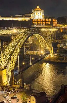 a bridge over a river with a city at night at Porto Bello - Apartamento - 8 in Porto