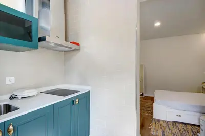 a kitchen with blue cabinets and a sink at Porto Bello - Apartamento - 8 in Porto
