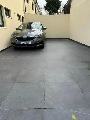 a car parked in a parking lot next to a building at House Real Companhia 55/53 in Vila Nova de Gaia