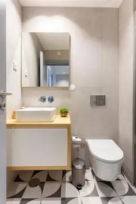 a bathroom with a sink and a toilet and a mirror at Almada 505 City Center Duplex in Porto