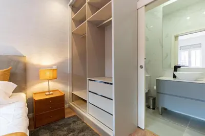 a bedroom with a sink and a bed and a mirror at Dellarose Max in Porto