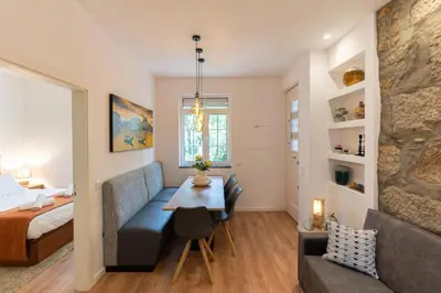 a room with a bed and a couch and a table at Dellarose Max in Porto