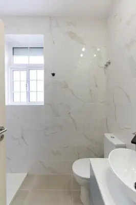 a white bathroom with a toilet and a sink at Dellarose Max in Porto