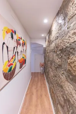 a hallway with paintings on the wall in a house at Dellarose Max in Porto
