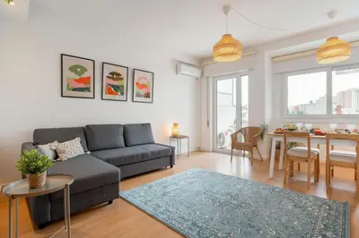 a living room with a couch and a table at Host Wise - Spacious Modern Flat w Balcony in Porto