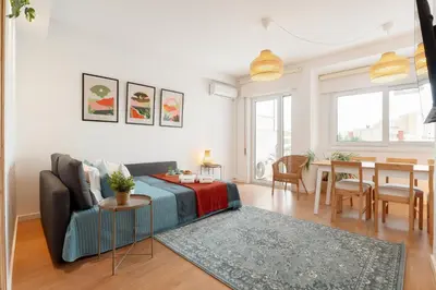 a living room with a couch and a table at Host Wise - Spacious Modern Flat w Balcony in Porto