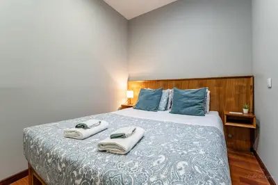 a bedroom with a bed with two towels on it at Experience the Charm Porto Apartment with Terrace in Porto