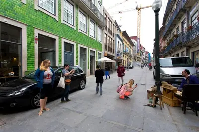 a group of people standing on a city street at Flower 45 Suite @ Rua das Flores in Porto