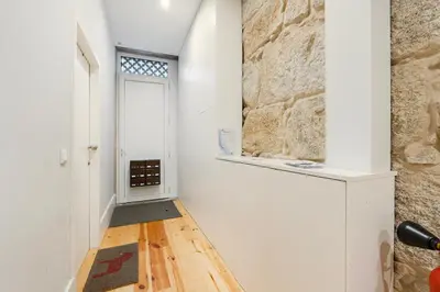 a hallway with a door and a stone wall at GuestReady - Comfortable Retreat in Porto in Porto