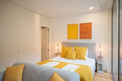 a bedroom with a bed and a couch at Golden Factory Apartment Downtown, Terrace and AC in Porto