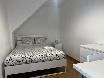 a colorful bed with two pillows in a bedroom at Taipas Guest House in Porto
