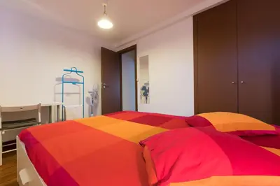 a bedroom with a colorful bed in a room at Taipas Guest House in Porto