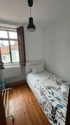 a kitchen with a washing machine and a sink at Taipas Guest House in Porto