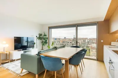 a kitchen and dining room with a table and chairs at GuestReady - Central Park in Porto in Porto