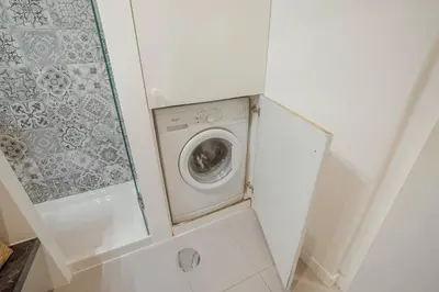 a washer and dryer in a small room at Santa Catarina Apartment by Hosty in Porto