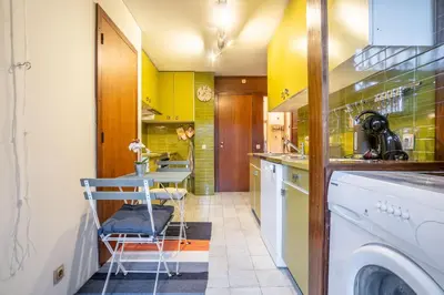 a kitchen with a washing machine and a sink at Casa Jardim by LovelyStay in Porto