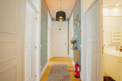 a hallway with a white door and a rug at Bonfim Premium by Hosty in Porto