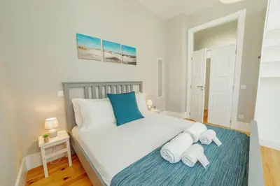 a bedroom with a bed with two towels on it at Bonfim Premium by Hosty in Porto