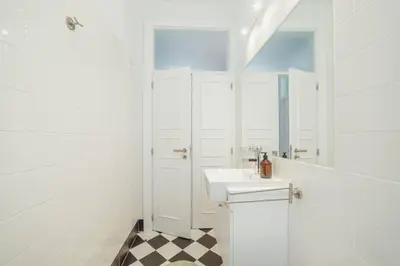 a bathroom with a sink and a mirror at Bonfim Premium by Hosty in Porto