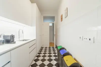 a kitchen with a checkered floor and a couch in a room at Bonfim Premium by Hosty in Porto