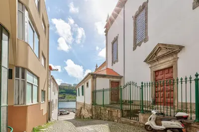 a scooter parked in a alley between two buildings at Cais das Pedras Duplex by Cozy Stay in Porto