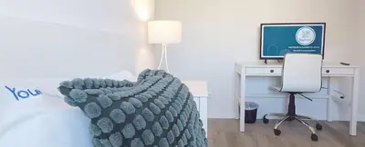 a bedroom with a bed and a desk with a computer at Casa del Charm With Terrace in Vila Nova de Gaia