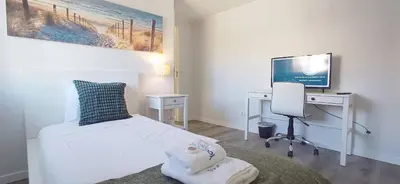 a bedroom with a bed and a desk and a television at Casa del Charm With Terrace in Vila Nova de Gaia
