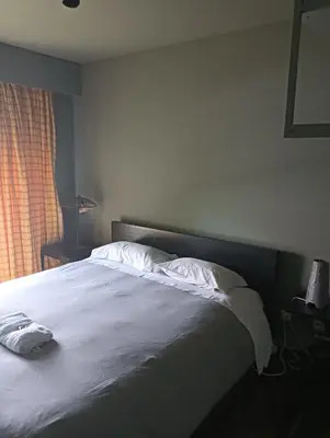 a bed with white sheets and pillows in a bedroom at Praceta in Porto