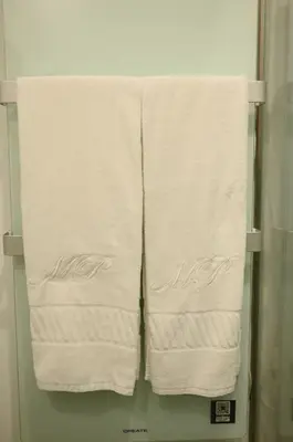 three towels hanging on a towel rack in a bathroom at Douro Premium Garden by MP in Vila Nova de Gaia