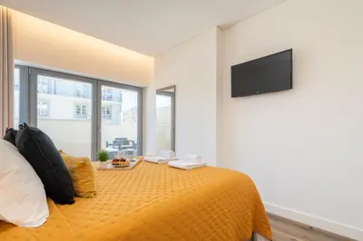 a bedroom with a bed and a flat screen tv at Host Wise - Fervença Boutique Palace in Vila Nova de Gaia