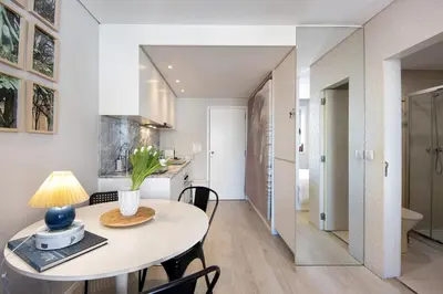 a kitchen and dining room with a table and chairs at The Plaza Boavista in Porto