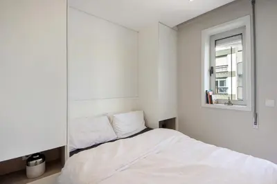 a bedroom with a bed and a window at The Plaza Boavista in Porto