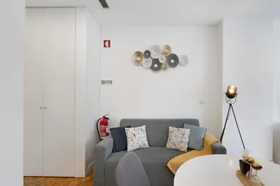 a living room with a couch and a table at Seni's House in Porto