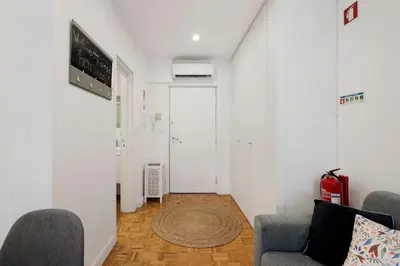 a living room with two chairs and a rug at Seni's House in Porto