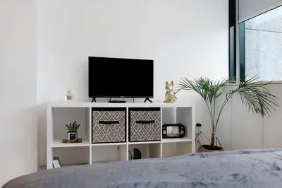 a white cabinet with a television on top of it at Seni's House in Porto