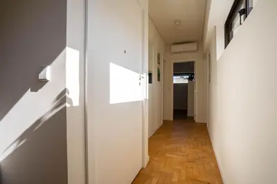 a hallway with white walls and a wooden floor at Porto Heights by LovelyStay in Porto
