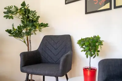 a chair and a table with two potted plants at Porto Heights by LovelyStay in Porto