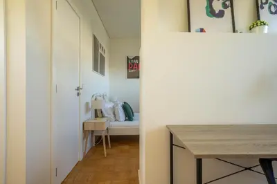 a hallway with a bed and a table in a room at Porto Heights by LovelyStay in Porto
