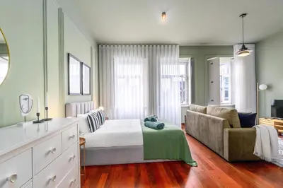 a bedroom with a bed and a couch at Maison d'Angelina: in the heart of Porto in Porto