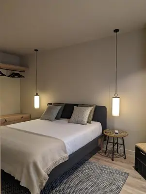 a bedroom with a large bed and two lights at BonJardim Apartment by Nove in Porto
