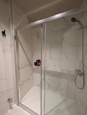 a shower with a glass door in a bathroom at BonJardim Apartment by Nove in Porto