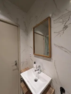 a white bathroom with a sink and a mirror at BonJardim Apartment by Nove in Porto