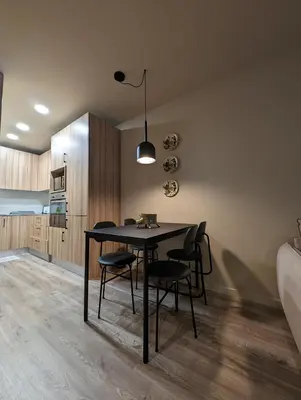 a dining room with a black table and chairs at BonJardim Apartment by Nove in Porto
