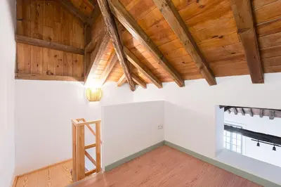 a room with a ladder and wooden ceilings at GuestReady - A brilliant stay near Ribeira in Porto