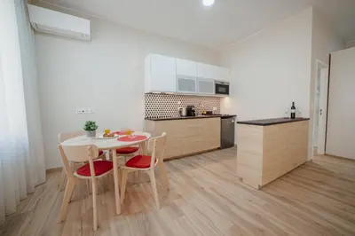 a kitchen with a table and chairs in a room at Trindade Deluxe by Hosty in Porto