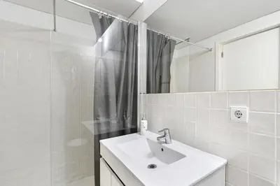 a white bathroom with a sink and a mirror at Oporto Sunset Blue Balcony in Porto