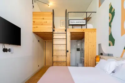 a room with a bunk bed and a tv at Limehome Porto Rua da Conceicao in Porto