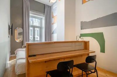 a room with a desk and two chairs at Limehome Porto Rua da Conceicao in Porto